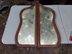 two mirrors sitting on top of a white table