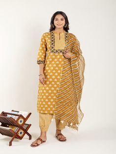 Mustard Yellow dabu flower printed straight kurta, has a mandarin collar, mirror and katha embroidered yoke, three-quarter sleeves and stripes Print afgani Pants has Elasticated Waistband Fabric: 100% Cotton Color: Mustard Yellow Note: Available in other colors Wash Care Instruction - Dry Clean Only The product will be shipped within 15-20 days of order placed Size Chart: Kurta Size XS S M L XL XXL XXXL Bust 36 38 40 42 44 46 Waist 32 34 36 38 40 42 Hip 38 40 42 44 46 48 Shoulder 14 14.5 15 15.5 Chanderi Straight Kurta With Printed Border, Unstitched Yellow Kurta With Block Print, Cotton Salwar Kameez With Printed Border For Spring, Festive Cotton Kurta With 3/4 Sleeve, Transitional Cotton Kurta With Dupatta, Spring Cotton Dupatta With Printed Border, Yellow Block Print Chanderi Kurta, Yellow Block Print Straight Kurta, Yellow Chanderi Kurta With Block Print