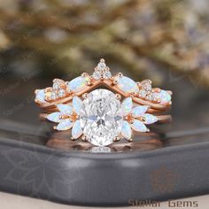 a ring with an oval cut diamond surrounded by white opals