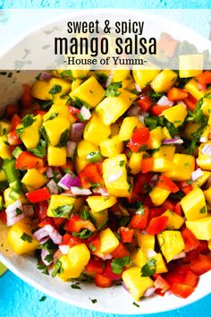 a white bowl filled with mango salsa on top of a blue table