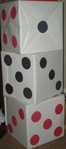 three white boxes with red and black polka dots on them, stacked in the shape of dices