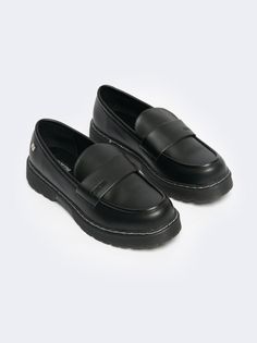 a pair of black loafers on white background