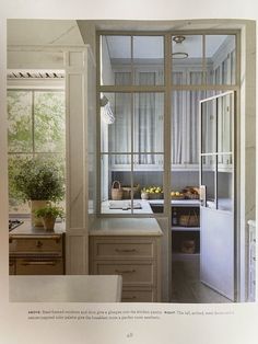 an image of a kitchen setting with glass doors and window sill in the center