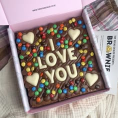 a box that has some kind of cake in it with the words i love you on it