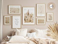 a bed with white pillows and pictures hanging on the wall above it in a bedroom