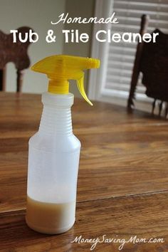 a yellow spray bottle sitting on top of a wooden table