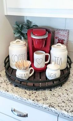 coffee cups and mugs are sitting on a tray