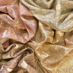 an assortment of different colored and patterned fabrics, including one with gold leaves on it