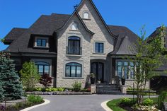 a large house with lots of windows and landscaping