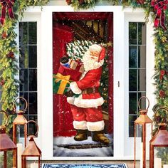 a door decorated with christmas decorations and santa clause holding a present in front of it