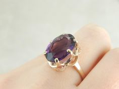 This is a moderate sized ring, suitable for every day wear, but with a bright and brilliant enough center stone to stand alone as a cocktail ring as well. The highly polished yellow gold mounting is a great frame for this deep purple fine amethyst. Metal: 14K Yellow Gold Gem: Amethyst 10.80 Carats Gem Measurements: 17.6 x 11.8 mm, Oval Ring Size: 8.75 Marks: "14K" Stamped on the inside band Amethyst Cocktail Ring, Oval Ring, Oval Rings, Gold Gift, Cocktail Ring, Eternity Bands, Cocktail Rings, Deep Purple, Sapphire Ring