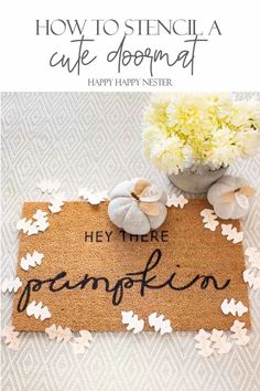 a welcome mat with the words hey there pumpkin on it and flowers in a vase