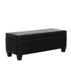 a black leather bench sitting on top of a white floor