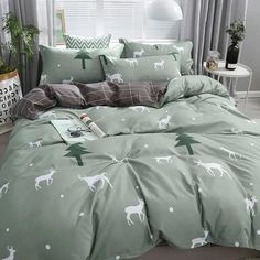 a bed room with a neatly made comforter and pillows covered in deer print on it