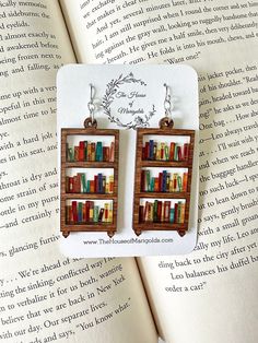 Book Earrings| Bookshelf Earrings| Reader Gifts| Book Earring Dangle| Book Club Gifts| Librarian Gift by thehouseofmarigolds on Etsy https://www.etsy.com/listing/1415975635/book-earrings-bookshelf-earrings-reader Bookshelf Earrings, Book Club Gifts, Reader Gifts, Ears Pierced, Weird Jewelry, Book Earrings, Bookclub Gifts, Earring Dangle, Gifts For Librarians