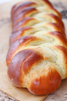 a long loaf of bread sitting on top of a piece of paper with the words braided easy egg bread