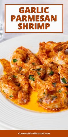 garlic parmesan shrimp on a white plate with orange sauce and garnish