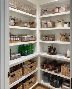 an organized pantry with lots of bottles and baskets