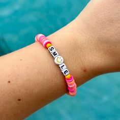 This bracelet serves as a friendly reminder to always Smile.  I have a range of sizes, including 5.5", 6", 6.5", and 7". Bracelet Care:  Keep the bracelet out of the water as much as you can because it stretches out the string and causes the beads to fade. The gold beads on the bracelet will gradually wear off and become darker the more you wear it.  Do not hesitate to message me if you have any questions. I'll respond to you as soon as I can. Inspirational Hypoallergenic Friendship Bracelets, Meaningful Pink Friendship Bracelets, Pink Meaningful Bracelets For Friendship, Inspirational Pink Adjustable Bracelets, Inspirational Pink Bracelet With Adjustable Fit, Inspirational Pink Adjustable Bracelet, Flexible Friendship Bracelets With Letter Beads, Inspirational Adjustable Pink Name Bracelet, Adjustable Smiley Face Friendship Bracelets