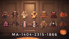 an image of halloween sweaters hanging from hooks in front of a wall with pumpkins