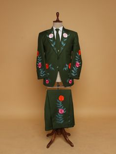 a green suit with red flowers on it