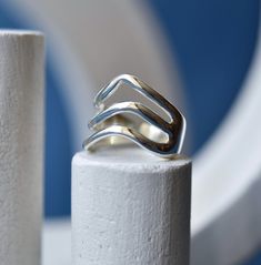 A wavy ring, made from .925 sterling silver, using the lost wax casting process. One of the oldest methods of jewellery making around, lost wax casting dates back to the 3rd century BC.    This ring would make the perfect piece of minimalist jewelry very substantial and yet incredibly comfortable. Super smooth and sleek design, this one is a statement piece!  It is comfortable enough for everyday wear but is also the perfect cocktail ring for special occasions! We offer worldwide express shippin Minimalist Sterling Silver Wavy Ring, Modern Silver Wavy Rings, Adjustable Sterling Silver Wavy Rings, Sterling Silver Wavy Promise Ring, Wavy Silver Promise Ring, Sterling Silver Promise Ring With Wavy Shape, Wax Casting Rings, Lost Wax Casting Rings, Wax Carved Ring