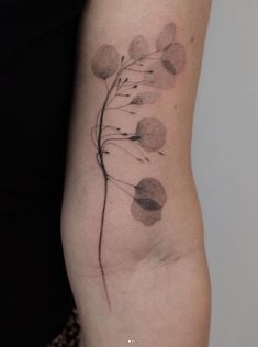 a woman's arm with a flower tattoo on the left side of her body