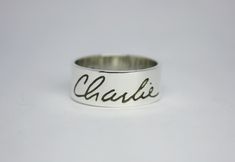 Actual Handwriting Ring. Personalized ring. Stacking Ring. Mom Ring. Sterling Silver Ring Words, Names. Engraved Ring. Metalsmith Sterling silver ring handmade, with the names of your choice. The inscription can be done inside or outside the ring. The inscription also is made by hand. I do not use letter stamped. I can represent your letter written by you.  Measures: width 8 mm, thickness 1,2 mm Please send me a convo or let me know in my mail terereyesjoies@gmail.com, your attachment with your Inscription. I'll give you a sketch before starting work so you can see how it will look. Use the drop-down below the price for choose only one engraving, or engraving on both sides, and you can also choose if you want color in your ring.  Your new beautiful handmade ring is packaged ready for gift Customizable Adjustable Sterling Silver Engraved Ring, Adjustable Customizable Engraved Sterling Silver Ring, Silver Hand Stamped Promise Ring, Elegant Hand Stamped Promise Rings, Elegant Promise Rings With Hand Stamping, Hand Stamped Silver Ring, Silver Engraved Adjustable Promise Ring, Customizable Adjustable Silver Engraved Ring, Custom Adjustable Wedding Jewelry