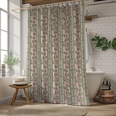 a bathroom with a pink shower curtain next to a bath tub