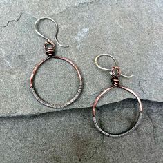 These lovely copper circle earrings have been textirized and patina'ed and the wrapped in sterling silver wire for a unique, artisan look to them.  They are hung on handmade, artisan sterling silver earwires and measure about 2 inches long. Copper And Silver Jewelry, Silver Copper Wrap Earrings Gift, Unique Hand Wrapped Silver Earrings, Adjustable Silver Wrap Earrings In Copper, Adjustable Silver Copper Wrap Earrings, Artisan Silver Jewelry With Copper Wire, Artisan Hand Wrapped Copper Earrings, Silver Hoop Jewelry Made Of Copper, Hand Forged Silver Jewelry From Copper Wire