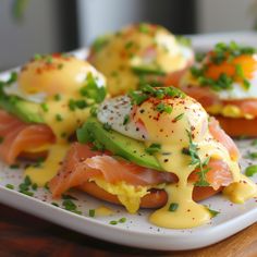 eggs, salmon and avocado on toasted bread with hollandaise sauce