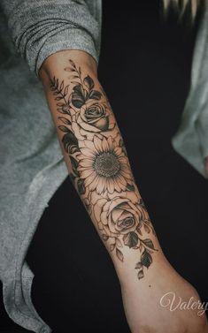 a woman's arm with sunflowers on it