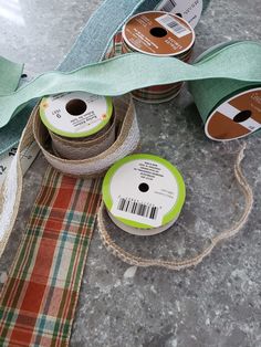 three spools of green ribbon on top of a table