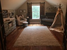 a baby's room with a crib, rocking chair, and dresser in it