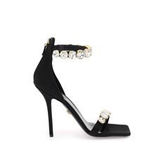 Versace Sandals Made Of Silk Satin And Embellished With Maxi Crystals On The Front Band And Ankle. Rear Zipper Closure, Leather Insole And Leather Sole. Materal: 72% Vi 28% Se. Made In: Italy. Color: Black. Collection: Fall - Winter 2023. Sku: 1011403 1a04185. Heel Height: 8,5 Cm. Modecraze Is An Online Platform That Offers The Best Designer Products From Europe To Customers All Over The World. Our Exclusive Partnerships With European Retailers Ensure That We Curate A Wide Selection Of Authentic Luxury Crystal Embellished Ankle Strap Sandals, Luxury Rhinestone Open Toe Sandals, Luxury High Heel Embellished Sandals, Crystal Embellished Open Heel Sandals For Gala, Luxury Rhinestone Cocktail Sandals, Luxury Embellished High Heel Sandals, Designer Ankle Strap Sandals With Rhinestones, Designer Rhinestone Sandals With Open Heel, Designer Sandals With Rhinestones And Open Heel