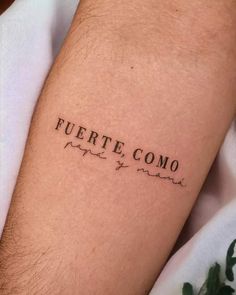 a person with a tattoo on their arm that says fuerte como and there is