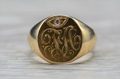 "The Tuscola Men's Antique 14K Hand Engraved Signet Ring set with Diamond. Crafted in 14 karat yellow gold, this men's ring features original hand engraved initials \"FA\" accented by a round diamond. The ring is currently a finger size 9.25 and is able to be resized for an additional charge. The engraved can be removed and engraved with the initials of your choice for an additional charge, also. Each piece has been hand selected and meticulously identified and graded by a Graduate Gemologist wh Heirloom Engraved Signet Ring For Anniversary, Heirloom Engraved Formal Rings, Formal Heirloom Engraved Rings, Heirloom Signet Ring With Engraving For Anniversary, Antique Rings With Engraving Option For Anniversary, Antique Engraved Ring With Polished Finish For Anniversary, Luxury 14k Stamped Signet Ring For Anniversary, 14k Gold Heirloom Engraved Ring, Classic Formal Engraved Intaglio Ring