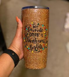 someone holding up a glittered cup with the words, my favorite thing is christmas carols on it