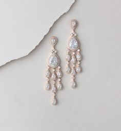 "Make a statement with these amazing long Rhodium, Yellow gold or Rose gold chandelier earrings. Created with teardrops set with Swarovski Pure Brilliance stones. Available in rose gold, yellow gold, rhodium finish. Earrings measure 3.5 inches long and 5/8\" at their widest. Matching bracelets: https://www.etsy.com/listing/674474135/rose-gold-bridal-bracelet-teardrop?ref=shop_home_active_1&pro=1&frs=1 https://www.etsy.com/listing/385432170/crystal-bridal-bracelet-rose-gold?ref=shop_home_ Cubic Zirconia Drop Chandelier Earrings, Glamorous Rose Gold Cubic Zirconia Chandelier Earrings, Rose Gold Drop Bridal Earrings, Rose Gold Dangle Teardrop Earrings, Rose Gold Cubic Zirconia Drop Bridal Earrings, Glamorous Cubic Zirconia Drop Chandelier Earrings, Rose Gold Cubic Zirconia Dangle Chandelier Earrings, Glamorous Rose Gold Dangle Bridal Earrings, Glamorous Rose Gold Dangle Chandelier Earrings