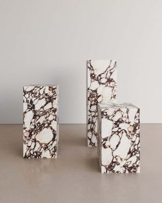 three white and black marble blocks sitting on top of a table