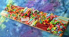 a wooden tray filled with lots of candy