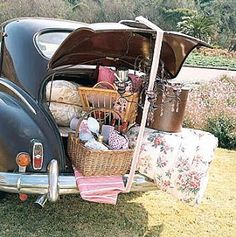 an old car is loaded with stuff and baskets