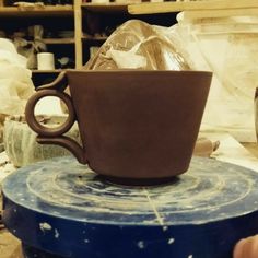 a coffee cup sitting on top of a blue table