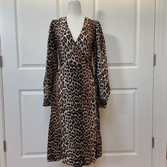 Take A Walk On The Wild Side With This Leopard-Printed Wrap Dress From Ganni. Crafted From Silk-Viscose, The Design Has A Surplice Neckline, Long Sleeves, And A Straight Silhouette. -Leopard-Print -Gathered Sleeves -Buttoned Cuffs -Ties At Waist -Slightly Stretchy Fabric -55% Viscose/45% Silk A Fr 36 Is Equivalent To A Us4 Leopard Print Midi Dress For Brunch, Fitted Leopard Print Dresses For Daywear, Fitted Leopard Print Day Dresses, Fitted Leopard Print Daywear Dress, Elegant Knee-length Leopard Print Dress, Button Down Denim Dress, Ganni Leopard Dress, Elegant V-neck Leopard Print Midi Dress, Ganni Dress