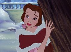 the princess from beauty and the beast holding onto a tree trunk in front of water