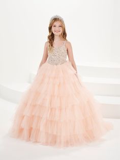 Your sweet girl will light up the room in this beaded long sleeveless dress with A-line ruffled tulle skirt by Tiffany Princess 13754. This sleeveless gown features a V-neckline with beaded embellishments, floor length A-line tulle skirt with tiered ruffles, sweep train, and a lace-up back. House of Wu Tiffany Princess Collection Spring 2024 Style Number: 13754 Fabric: Beading/Tulle Please note: There may be a loss of glitter while wearing this dress due to the nature of the fabric Colors: Blush Fabric Beading, Back House, Long Sleeveless Dress, Beaded Embellishments, Beaded Tulle, Girls Formal Dresses, 2024 Style, Sleeveless Gown, Princess Collection