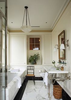 a bathroom with marble floors and white walls, along with a bathtub that has been decorated in black and white