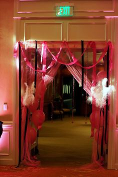 an entrance decorated with pink and black ribbons