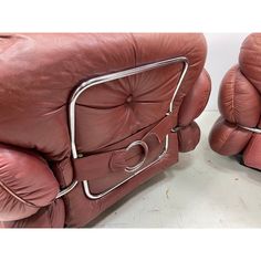 two red leather chairs sitting next to each other