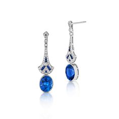 These lovely Art Deco style drop earrings are crafted in 18 karat white gold and feature two oval cut heated blue sapphires with a total weight of 8.09 carats. Adorning the two sapphires are 1.00 total carats of round brilliant cut diamonds and 0.44 total carats of calibre cut blue sapphires set with milgrain detailing. Reference Code: 34975 Shop other beautiful pieces in our Earring Collection.For inquiries on the piece please contact: boutique@shsilver.com Luxury Platinum Blue Earrings, Luxury Blue Platinum Earrings, Elegant Blue Platinum Earrings, Classic Blue Platinum Earrings, Elegant Sapphire Earrings With Polished Finish, Paris Ring, Sapphire And Diamond Earrings, Jewelry Appraisal, Earring Collection